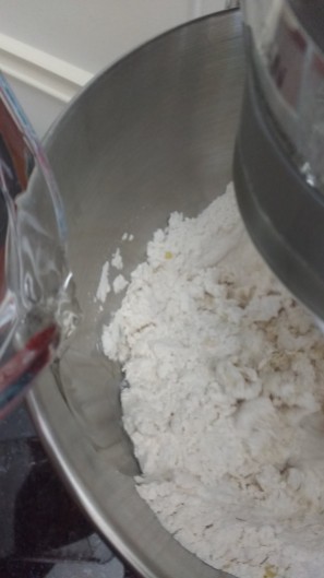 Add water gradually as you mix bread ingredients.
